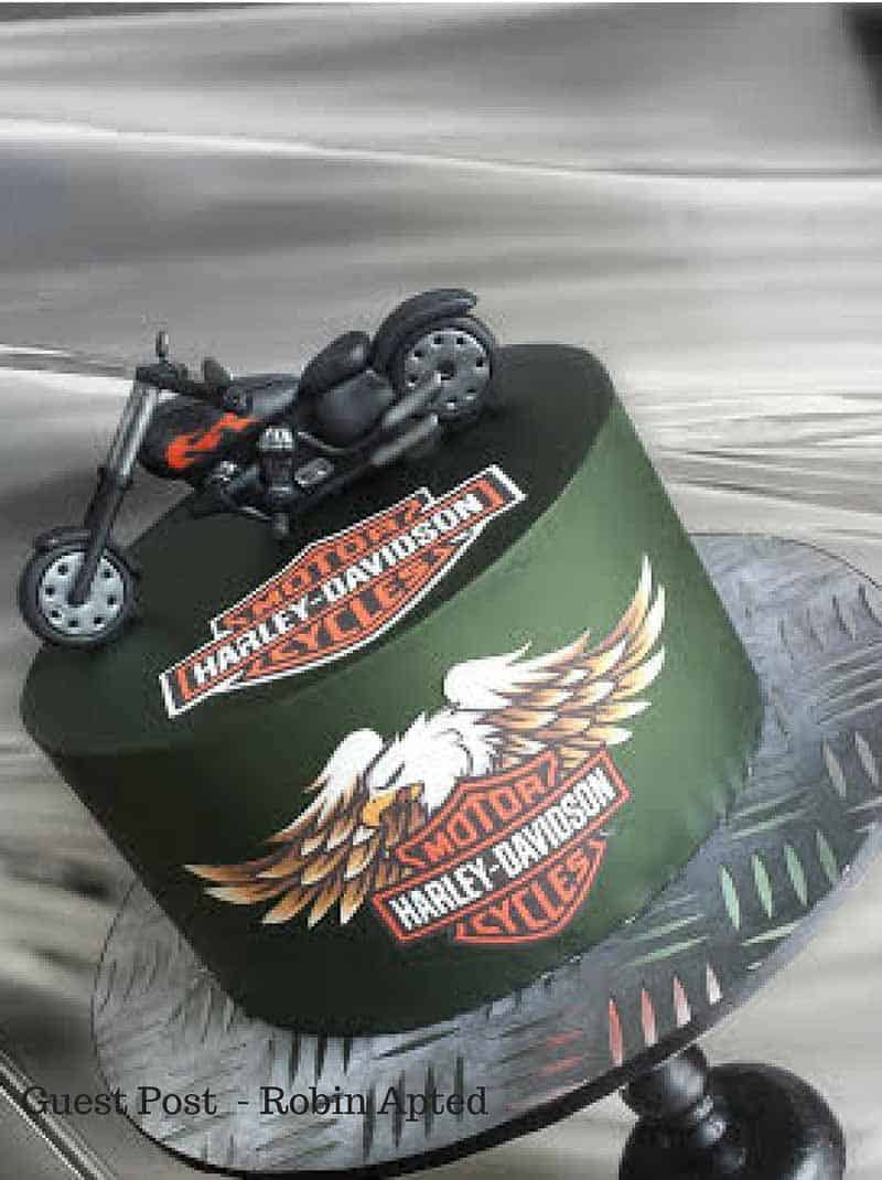 A cake decorated in a Harley Davidson theme.