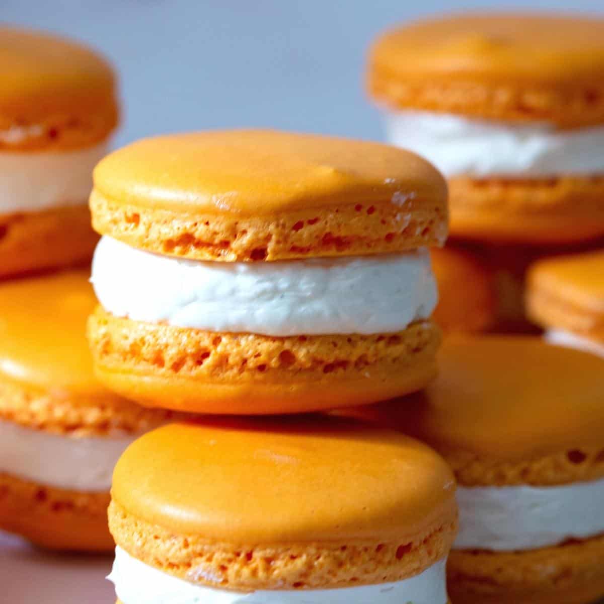 Orange flavored macarons on the table.
