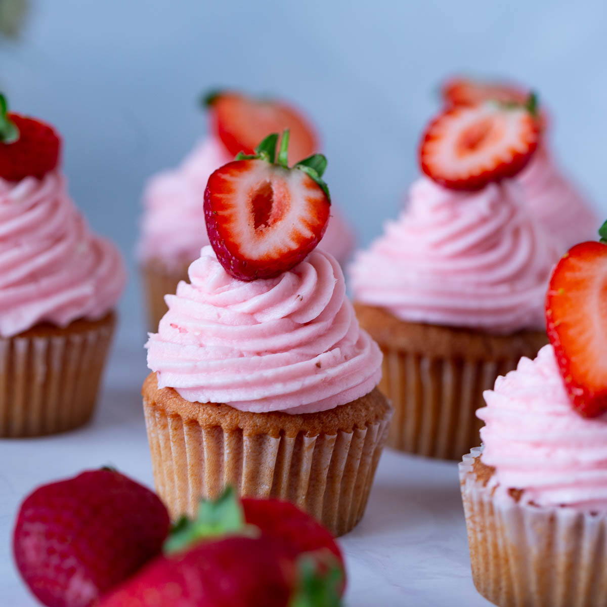 Frosted cupcakes with strawberries.