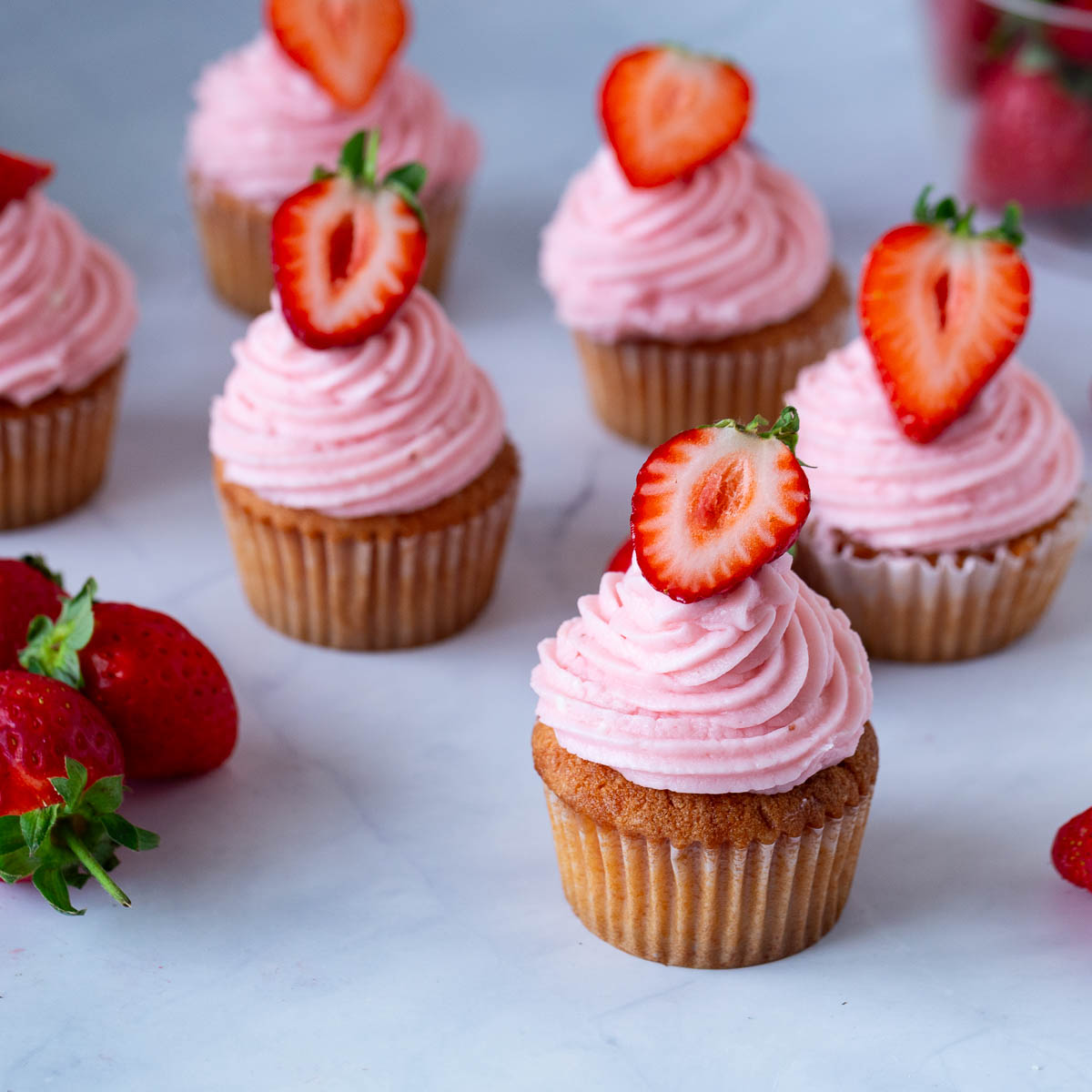 Cupcakes frosted with strawberry buttercream.