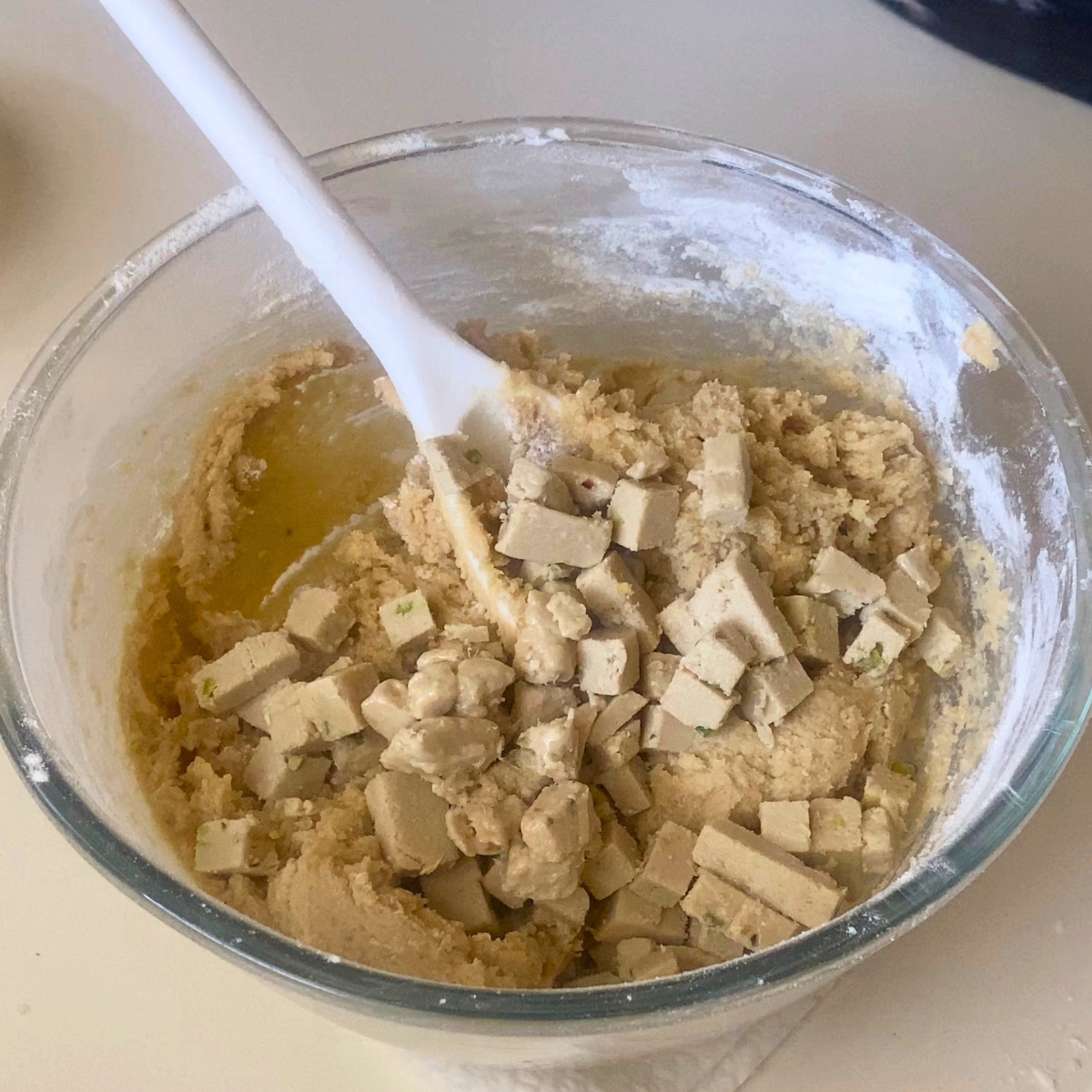 A glass bowl with halva cookie dough balls.