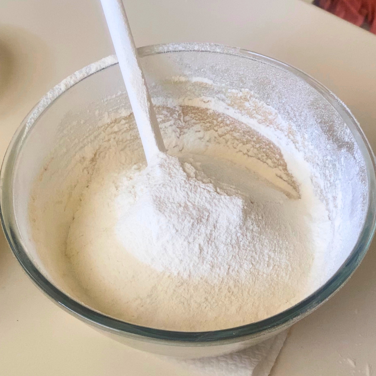 Adding flour to the cookie dough.