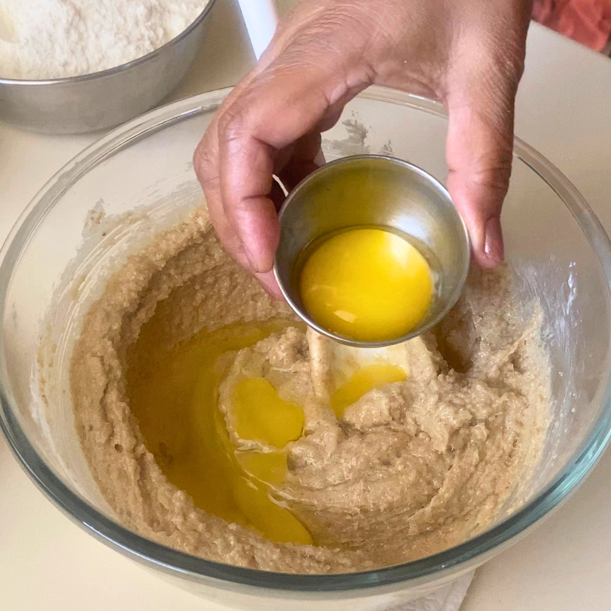 Adding egg and egg yolks to the cookie dough.
