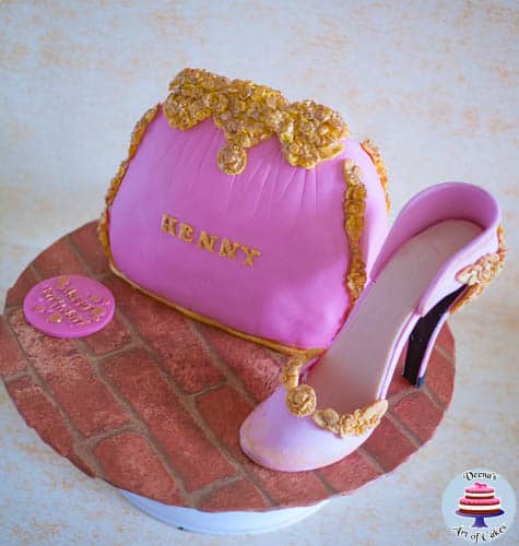 A cake decorated like a lady\'s handbag with a gum paste stiletto.