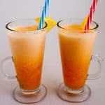 Two glasses with smoothies and straws