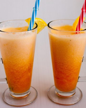Two glasses with smoothies and straws