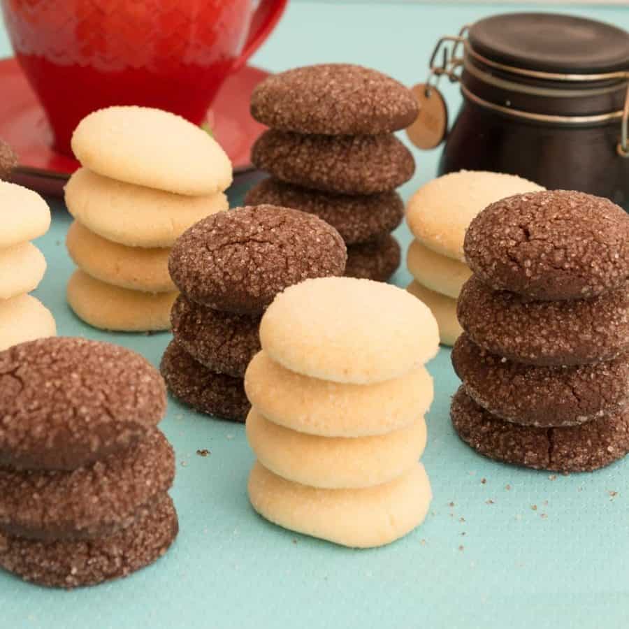Vanilla and chocolate shortbread cookies on a blue table