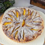 Frangipani nectarine tart dusted with powdered sugar.