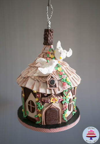 Progress photos of making a cake decorated to look like a hanging birdhouse.