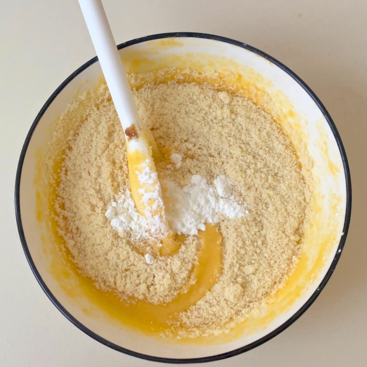 A white bowl making frangipani with almond flour.
