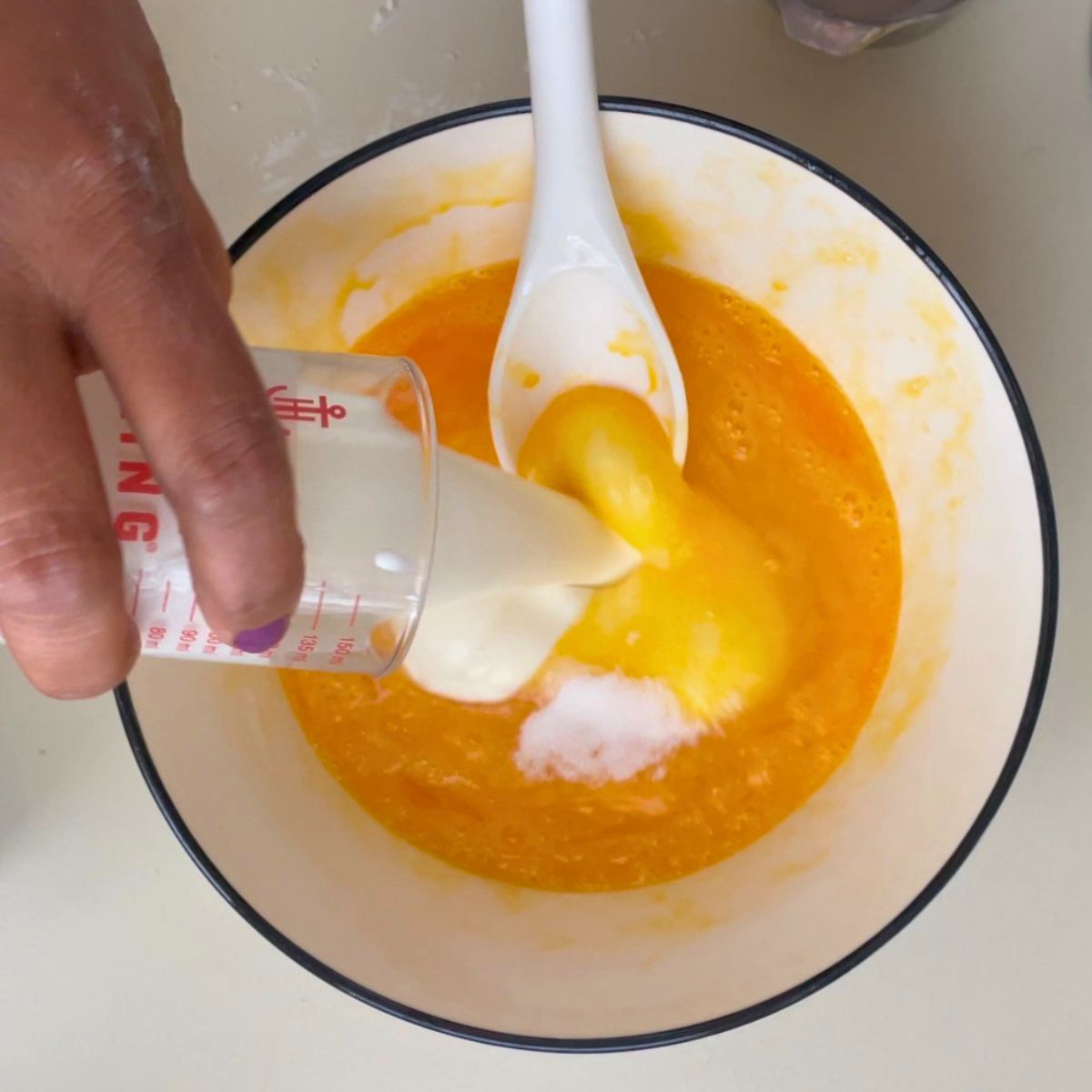 A white bowl making frangipani filling.