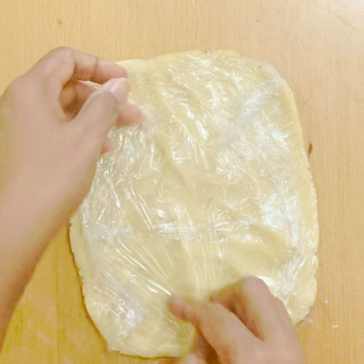 Shortcrust pastry wrapped in plastic wrap.