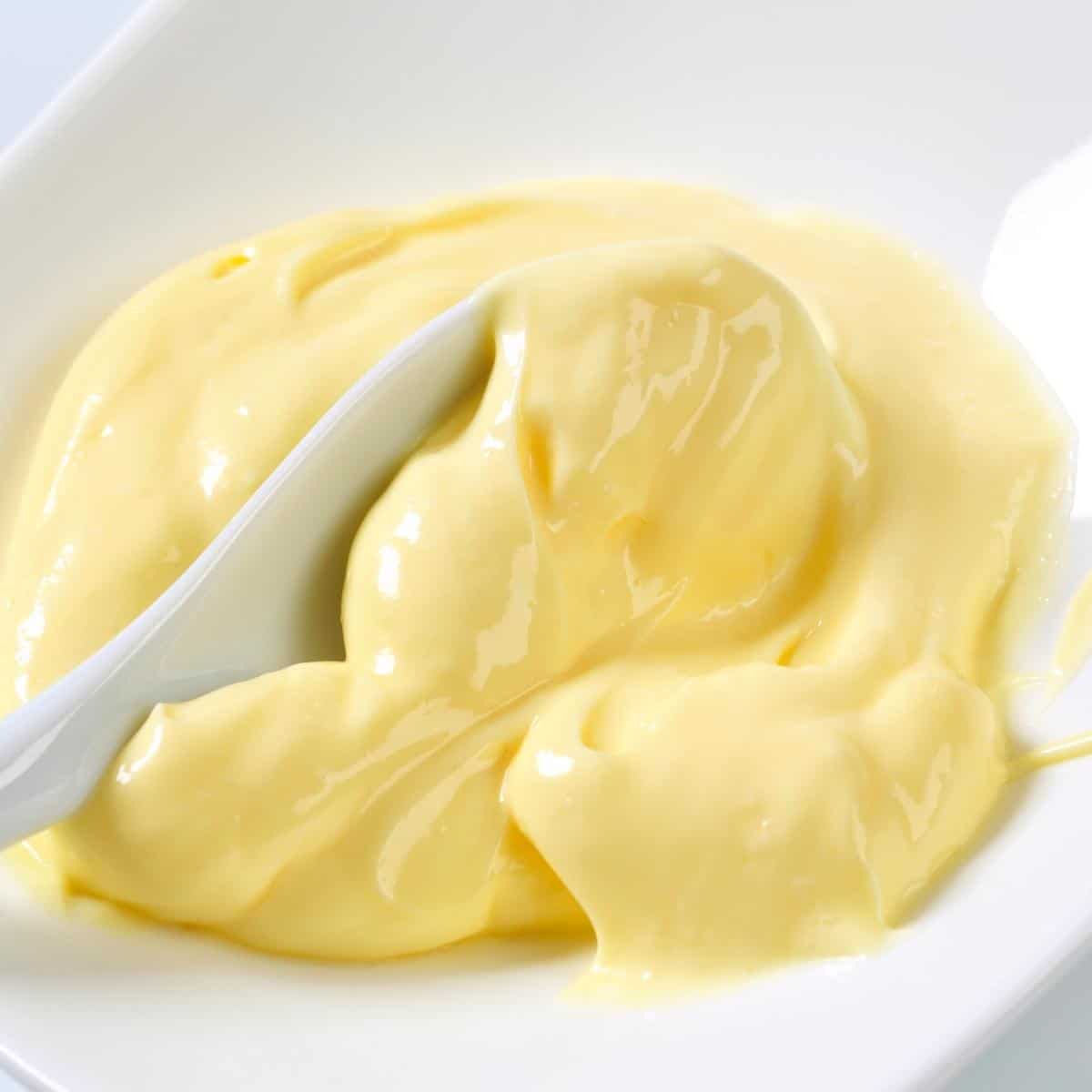 Custard in a bowl with spoon.