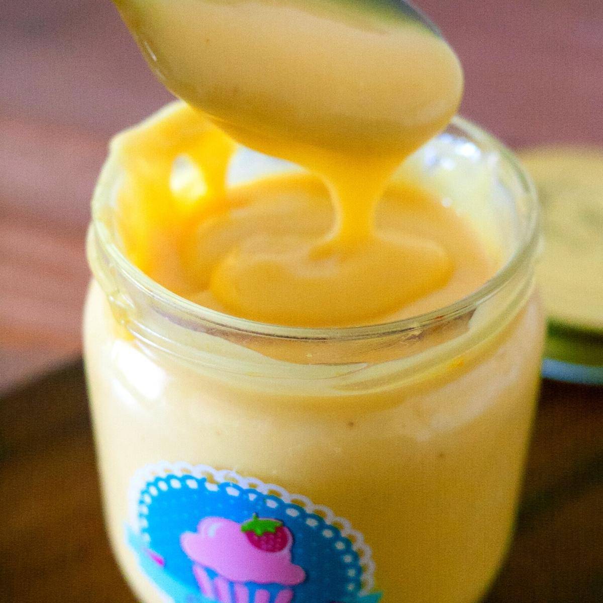 A jar and spoon with creme patissiere.
