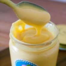 Vanilla custard cream in a mason jar with spoon.