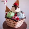 A cake decorated like a big ice cream sundae.