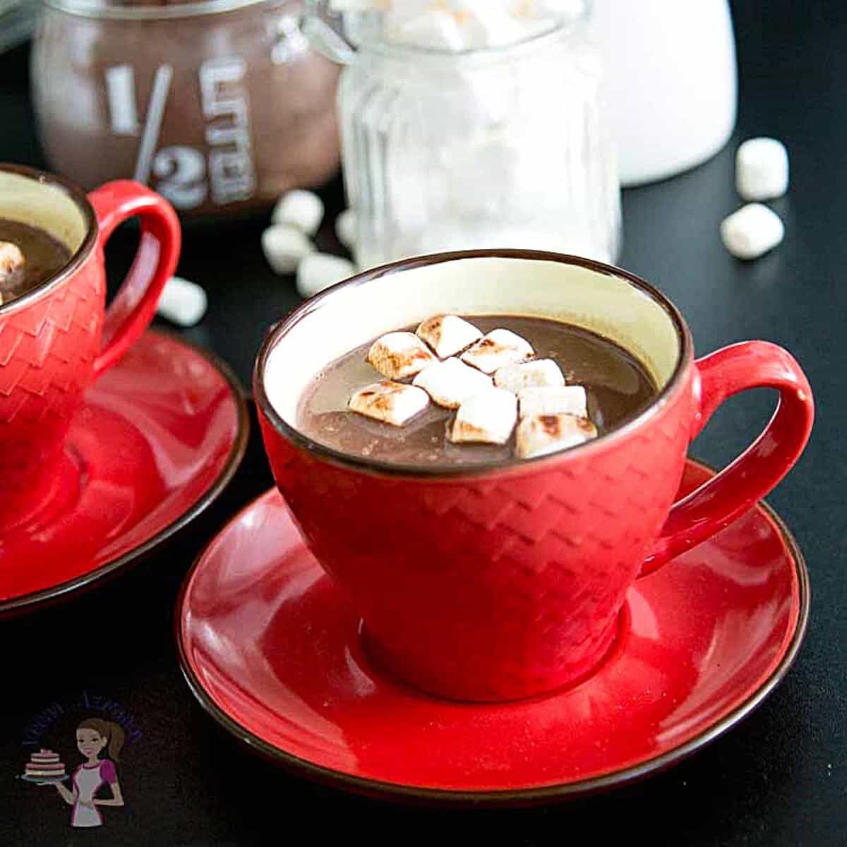 A red cup with hot cocoa and marshmallows.