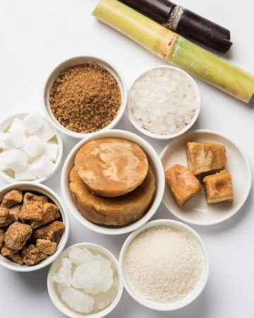 A variety of sugar types in small bowls.