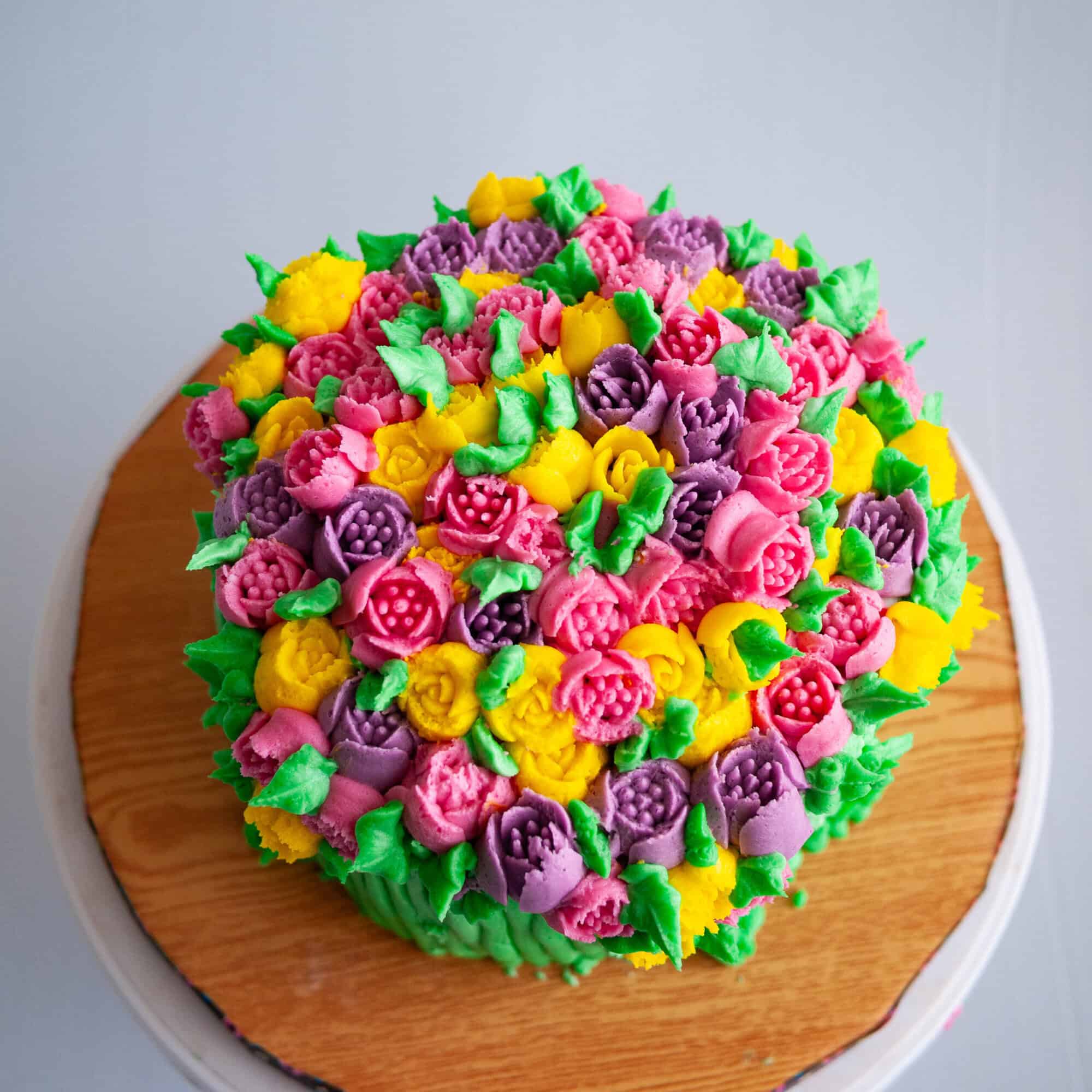 Ever wondered how to use those beautiful Russian Piping Tips? Today I'm going to share with you how to pipe flowers with these Russian Tips like a pro. My buttercream recipe and piping tips will give you the confidence to piping these buttercream flowers flawlessly every single time. A Cake frosted with Russian piping tips.