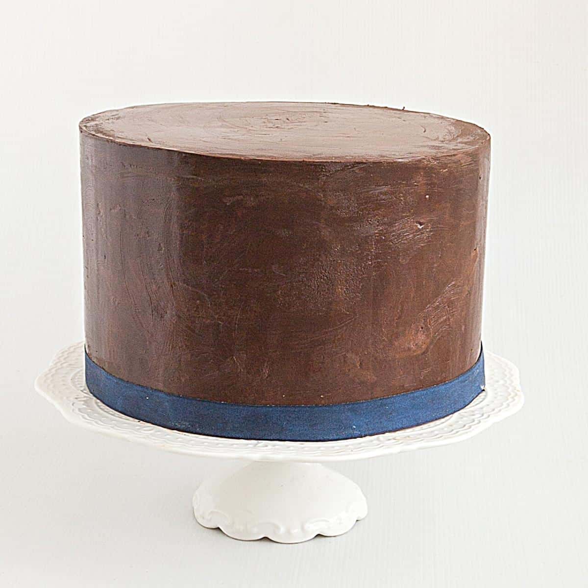 A cake frosted with ganache.