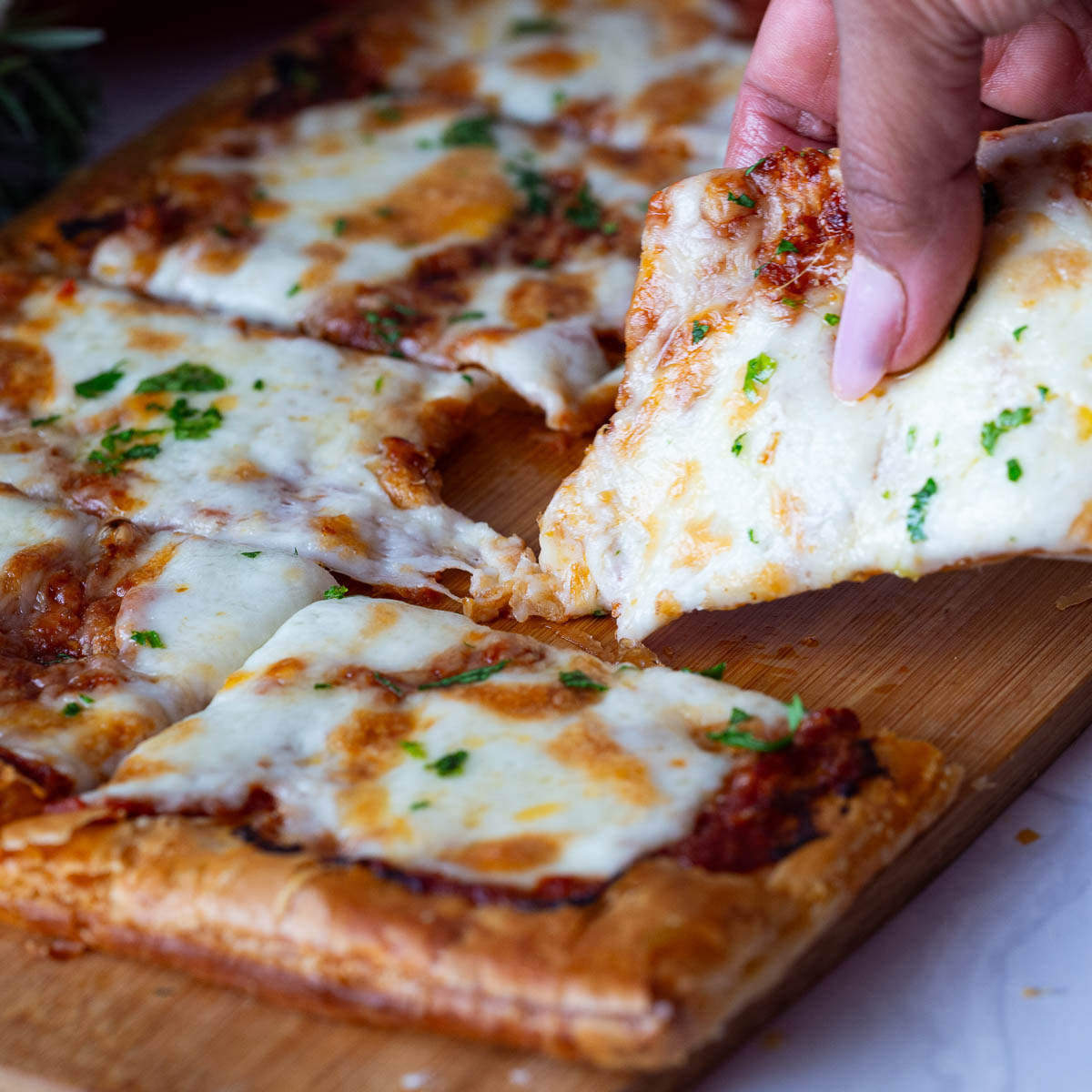 This has got to be the best red pesto pizza with peppers because it's quick, delicious and best of all super easy with almost every thing semi homemade making weekday day or kids snack time a breeze. A slice of pizza on the table.