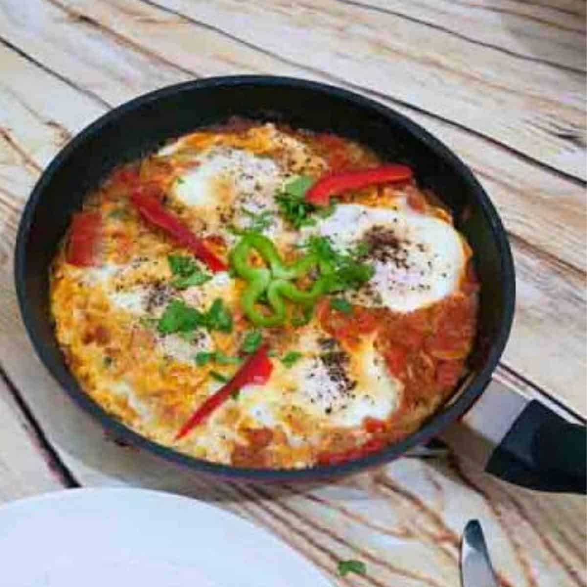 A skillet with shakshuka made with fresh tomatoes.