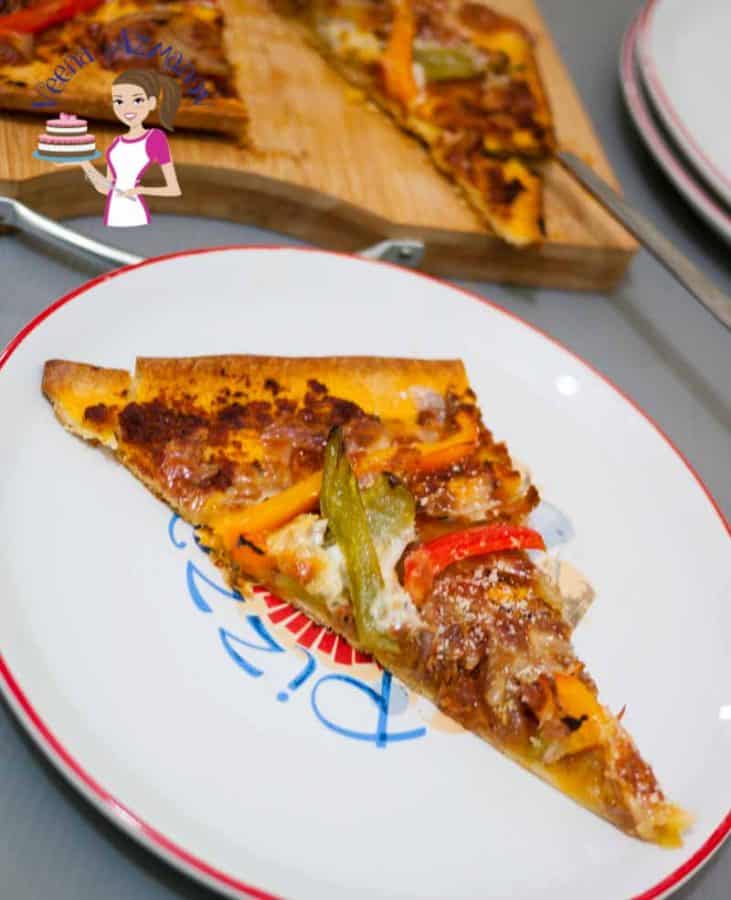 This has got to be the best red pesto pizza with peppers because it's quick, delicious and best of all super easy with almost every thing semi homemade making weekday day or kids snack time a breeze. A slice of red pesto pizza with bell peppers.