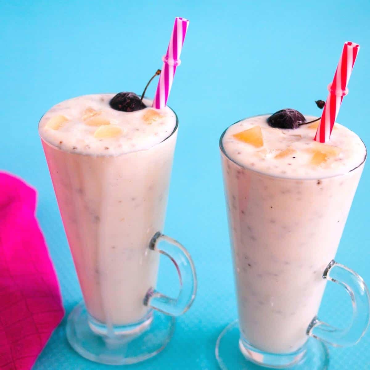 Two glasses filled with pina colada smoothie