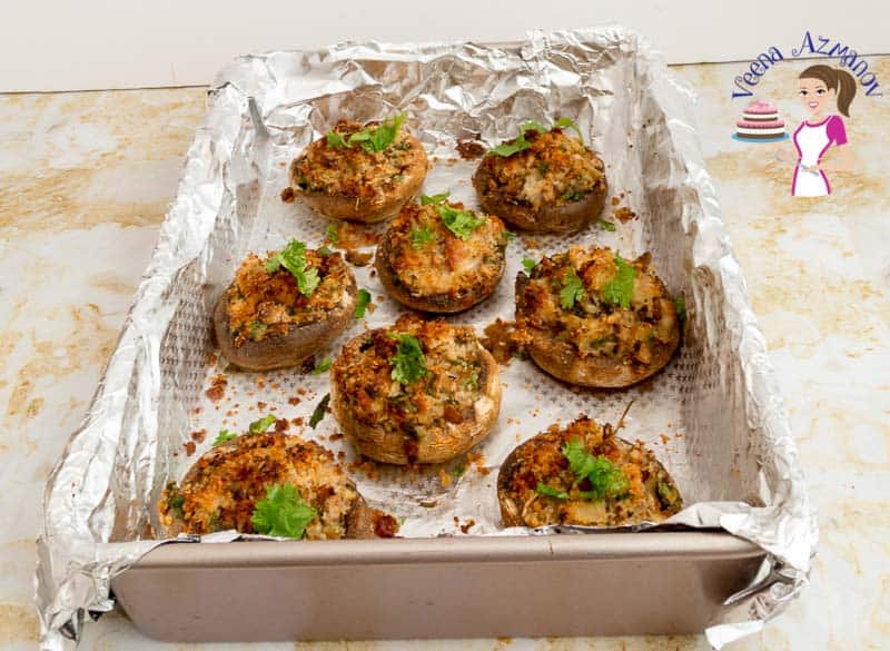 A baking tray with stuffed mushrooms.