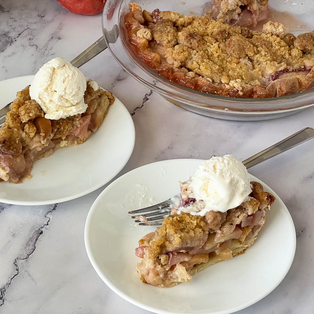 Slices of peach pie with ice cream on the table.