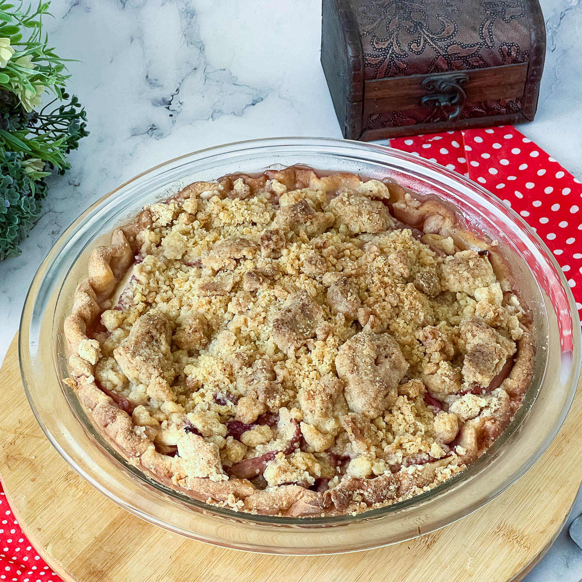 A baked pie with fresh peaches in a pie pan.