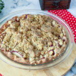 A fresh baked peach pie in a pie pan.