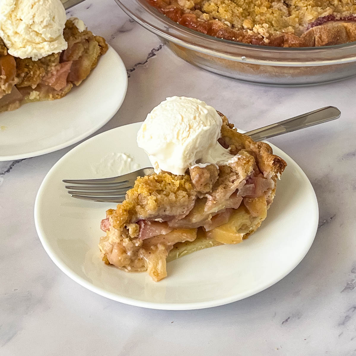A slice of peach crumble pie on the table.