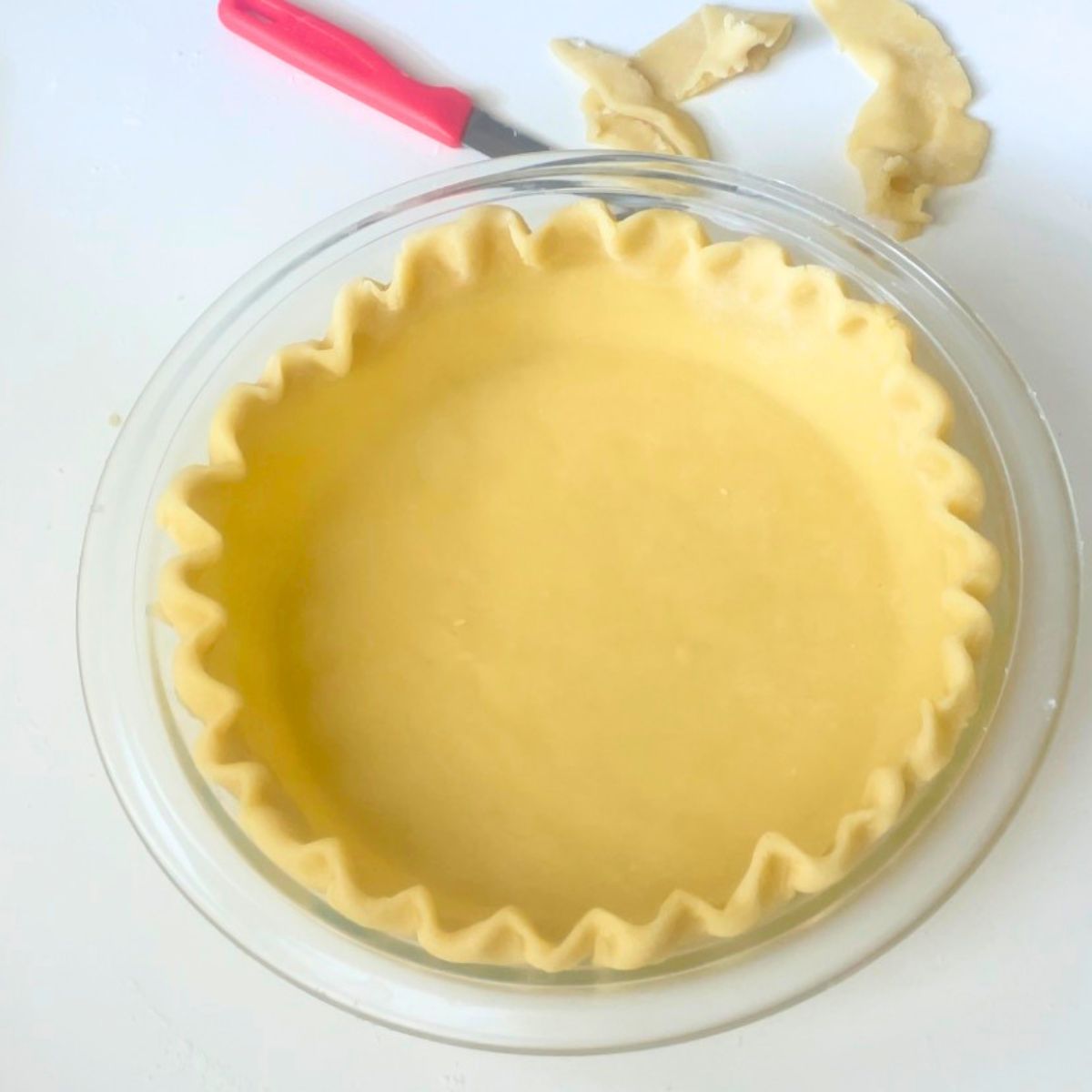 A pie pan with pie crust for baking.