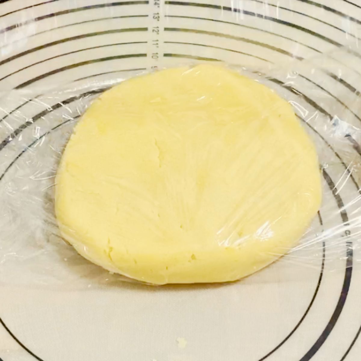 Pie dough wrapped in plastic.