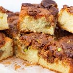 Sliced halva cake squares on a board.
