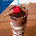 A smoothie garnished with strawberry and cocoa