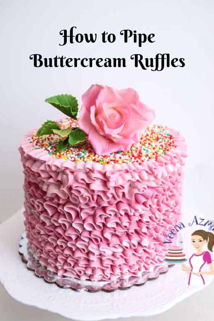 A pink buttercream ruffles cake with a sugar flower on top.