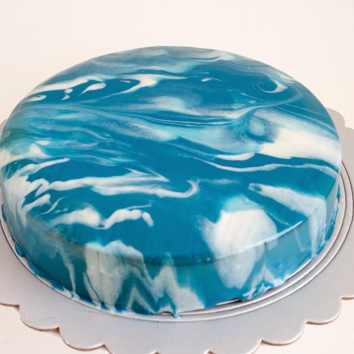 Cut chocolate mousse cake with mirror glaze.