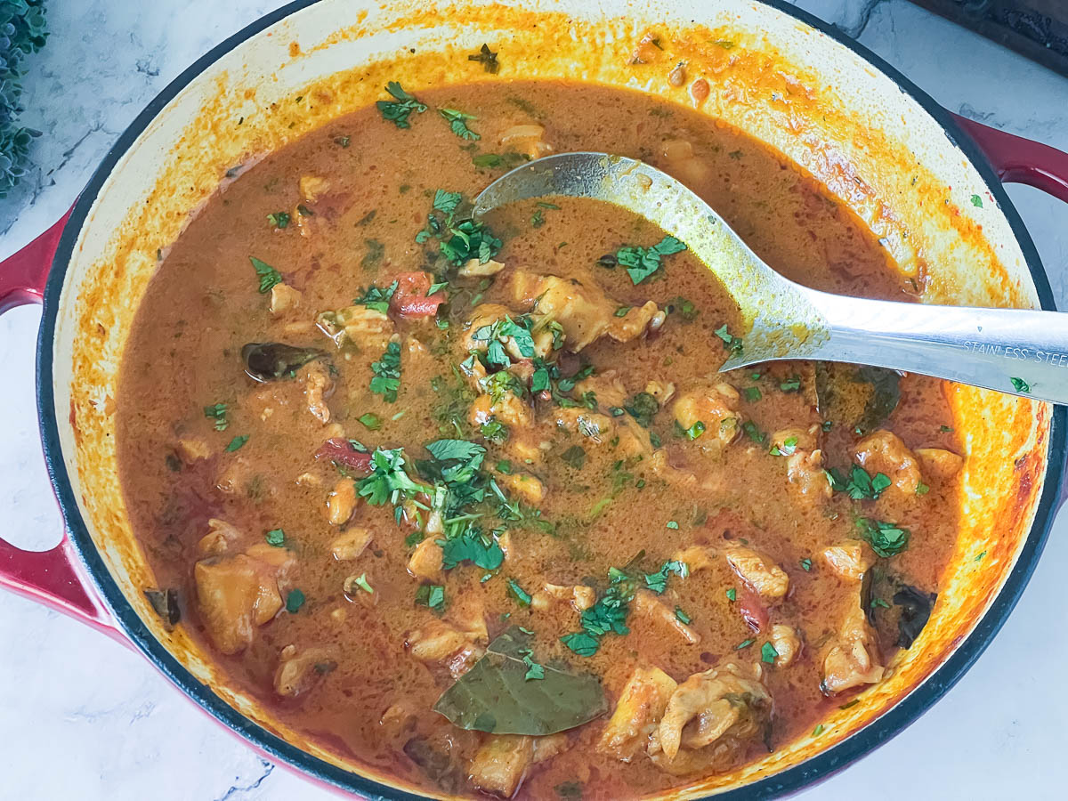 A skillet with chicken curry.