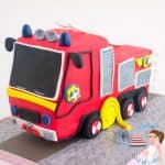 Fire truck cake on a cake board.
