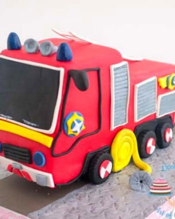 Fire truck cake on a cake board.