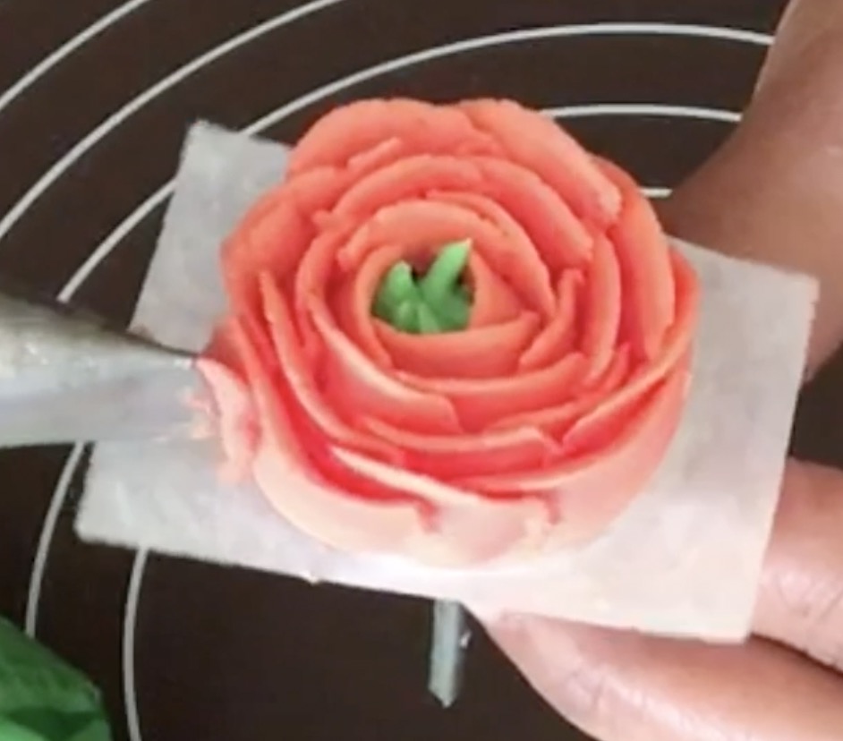 Piping a buttercream rununculus.