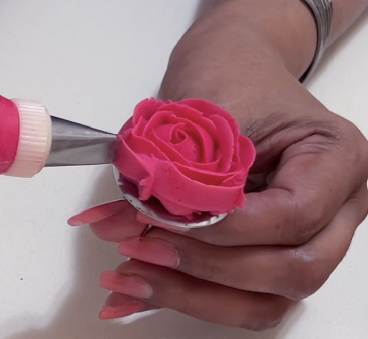 Piping a buttercream rose.