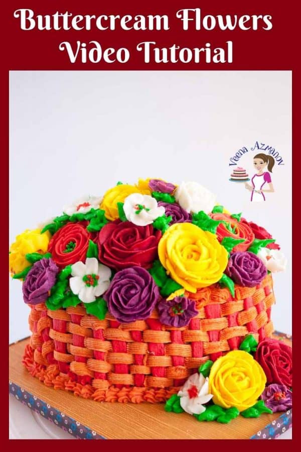Buttercream roses, ranunculus and blossoms on a basketweave cake.