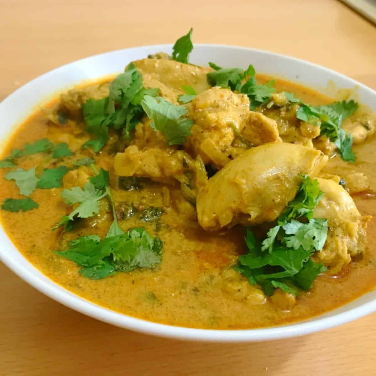 White Bowl with chicken curry made with curry powder.