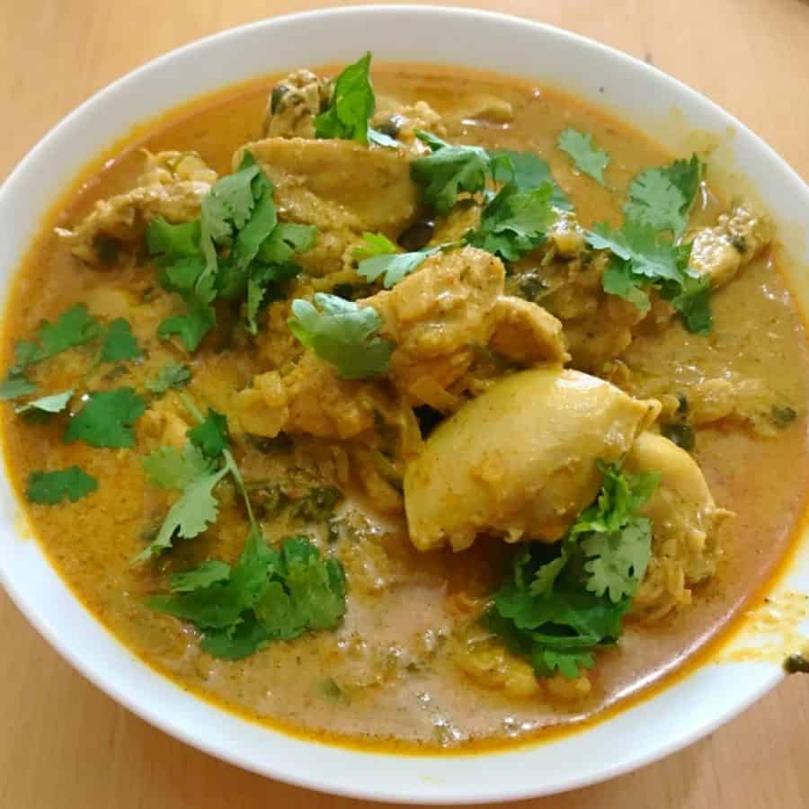 Chicken curry with curry powder in a bowl.