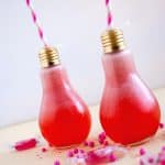 two light bulb shaped glasses with lemonade
