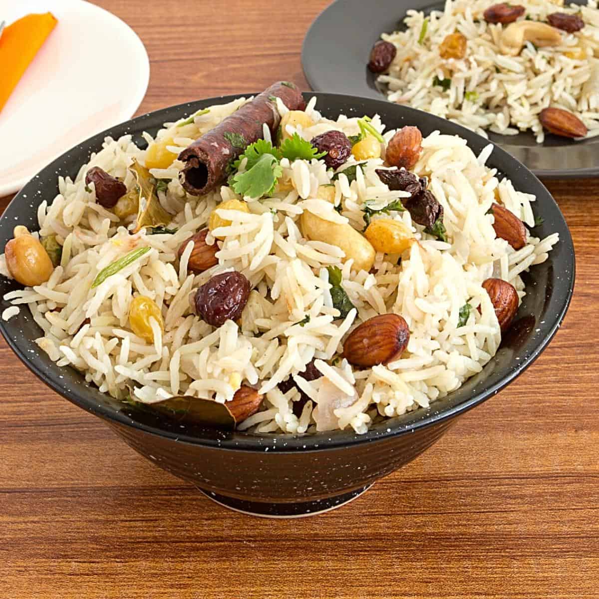 A black bowl with basmati rice pilaf.