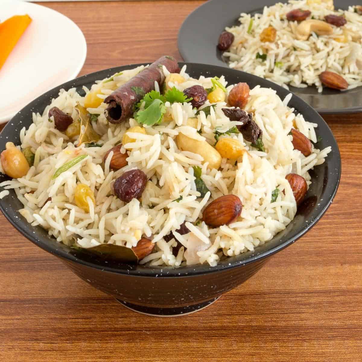 A black bowl with rice pilaf.